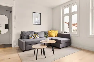 a living room with a couch and a table at Dinbnb Apartments I Views & Street Parking in Sandviken in Bergen