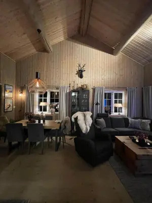 a living room with a table and a dining room at Leilighet i vakre Rauland in Rauland