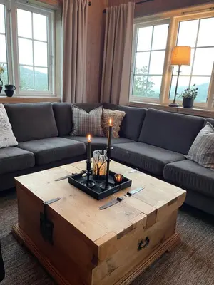 a living room with a couch and a coffee table with candles at Leilighet i vakre Rauland in Rauland