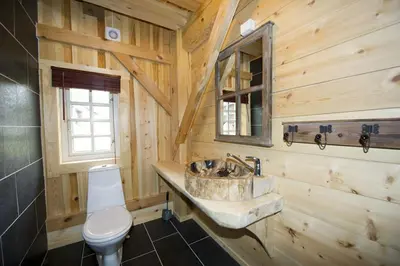 a wooden bathroom with a sink and a toilet at Grindastugu cabin right by Liatoppen Ski Centre. in Ål