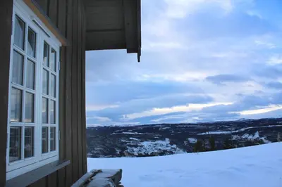 a window of a house with a view of the snow at Grindastugu cabin right by Liatoppen Ski Centre. in Ål