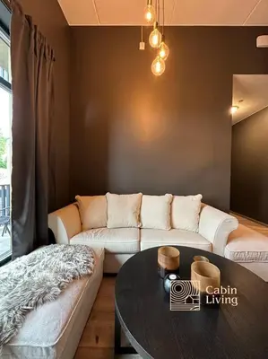 a living room with a couch and a table at New high standard apartment in Trysil with ski in out in Trysil