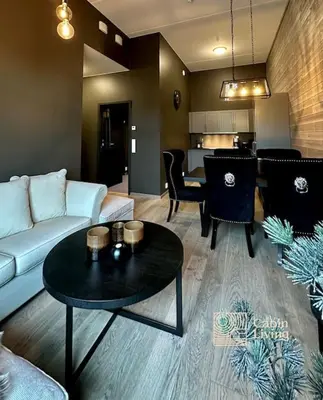 a living room with a couch and a table at New high standard apartment in Trysil with ski in out in Trysil