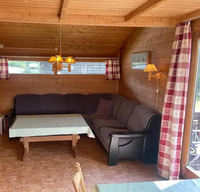 a living room with a couch and a coffee table at Midttun Camping og Feriehytter in Vossestrand