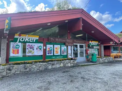 a joker fast food restaurant with a building at Midttun Camping og Feriehytter in Vossestrand