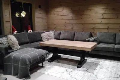 a living room with a couch and a coffee table at Stor og koselig hytte i Stryn in Stryn