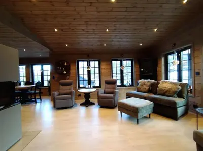 a living room with a couch and chairs and a table at Stor og koselig hytte i Stryn in Stryn