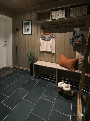 a room with a bench on a wooden wall at Beautiful apartment - high standard - Geilo centre in Geilo