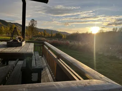 a wooden deck with a view of a field at Beautiful apartment - high standard - Geilo centre in Geilo