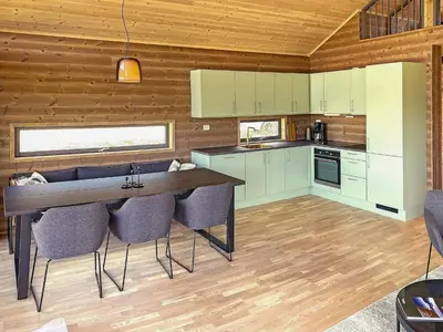 a kitchen with a table and chairs in a room at 6 person holiday home in Sollia-By Traum in Brenn