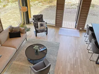 a living room with a couch and a table and chairs at 6 person holiday home in Sollia-By Traum in Brenn