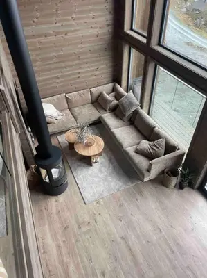 a living room with a couch and a table at Rindabotn Fjelltun ski in-ski out in Sogndal