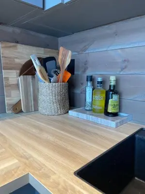 a kitchen counter with a container of cooking utensils at Rindabotn Fjelltun ski in-ski out in Sogndal