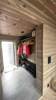 a small room with a closet with wooden walls at Rindabotn Fjelltun ski in-ski out in Sogndal
