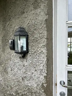 a light on the side of a building at Sveggvika Atlantic Home in Averoy