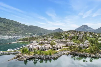 an aerial view of a home on an island in the water at Modern house by the Fjord in Sandane, Nordfjord. in Sandane