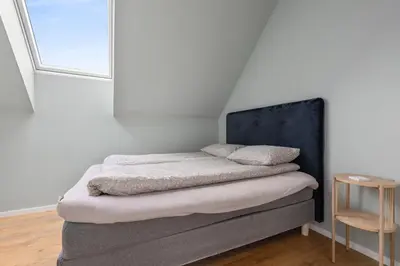 a bed with two pillows on it in a room at Modern house by the Fjord in Sandane, Nordfjord. in Sandane