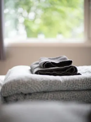 a pile of towels sitting on top of a bed at Modern and central apartment in Bergen in Bergen