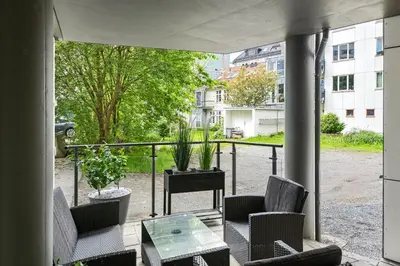 a patio with chairs and a table and a balcony at Modern and central apartment in Bergen in Bergen