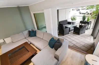 a living room with a couch and a table at Modern and central apartment in Bergen in Bergen
