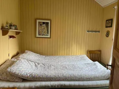 a bedroom with a large bed in a room at Sjarmerende hytte omgitt av vakker natur in Molde