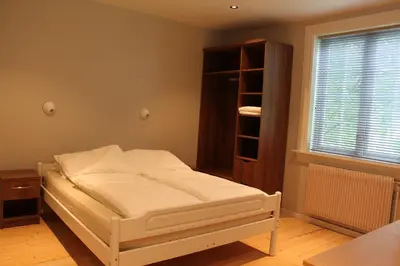 a small bedroom with a bed and a window at Elton Hotel in Raufoss