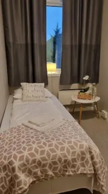 a bedroom with a bed and a window at Leirvik Vandrehjem in Leirvik