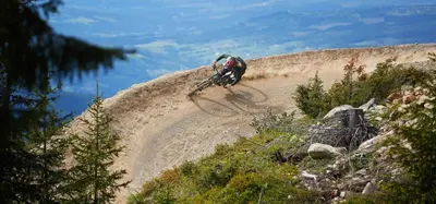 a person riding a bike on a dirt trail at Hafjell Front 220D 8pers, Ski inout , Downhill Bike in Hafjell