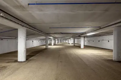 an empty parking lot with pillars in an empty parking garage at Hafjell Front 220D 8pers, Ski inout , Downhill Bike in Hafjell