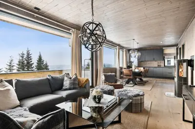 a living room with a couch and a table at Hafjell Front 220D 8pers, Ski inout , Downhill Bike in Hafjell