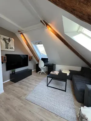 a living room with a couch and a tv at Central Two Room Apartment! in Trondheim