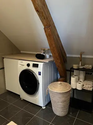a washer and dryer sitting in a kitchen at Central Two Room Apartment! in Trondheim