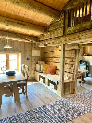 a bedroom with a bed and a table in a room at Kufjøset in Skjåk