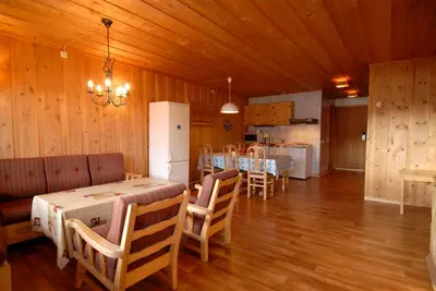 a dining room with a table and chairs and a kitchen at Bessheim Fjellstue og Hytter in Bessheim