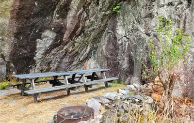 a picnic bench sitting next to a large tree at 4 Bedroom Stunning Home In Fjæra in Fjæra