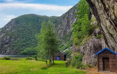 a cabin in the mountains next to a body of water at 4 Bedroom Stunning Home In Fjæra in Fjæra