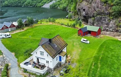 an aerial view of a house on a green field at 4 Bedroom Stunning Home In Fjæra in Fjæra