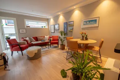 a living room with a couch and a table at Leilighet Damsgård , nær sentrum in Bergen
