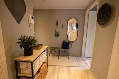 a hallway with a table and a chair in a room at Leilighet Damsgård , nær sentrum in Bergen