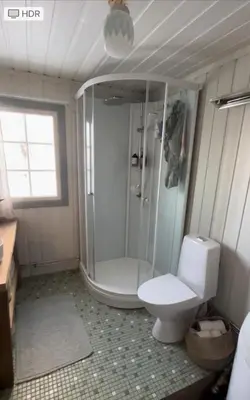 a bathroom with a shower and a toilet and a sink at Cozy family friendly cabin at beautiful location! in Geilo