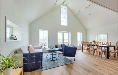a living room with a couch and chairs and a table at 3 Bedroom Lovely Home In Stolmen