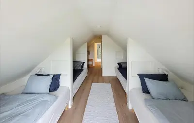 a white room with two beds and a hallway at 3 Bedroom Lovely Home In Stolmen