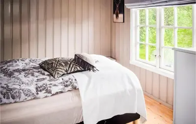 a bedroom with a bed with a comforter and pillows at 3 Bedroom Nice Home In Gol in Gol