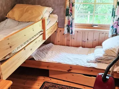 two bunk beds in a room with a window at 9 person holiday home in MOSTERHAMN-By Traum in Mosterhamn