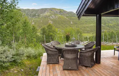a patio with a table and chairs on a deck at 4 Bedroom Nice Home In Hemsedal in Hemsedal
