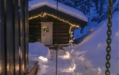 a cabin in the snow with christmas lights at 4 Bedroom Nice Home In Hemsedal in Hemsedal
