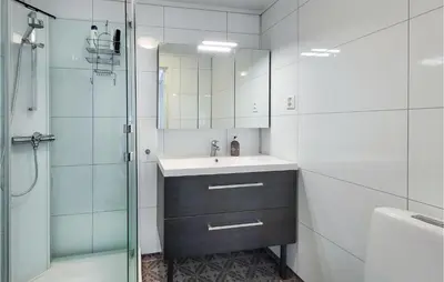a bathroom with a sink and a shower at Nice Home In Bremnes With Wifi in Bremnes