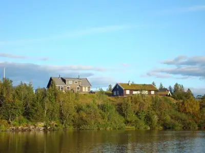 a house on a hill next to a body of water at Panoramahytte in Norheimsund