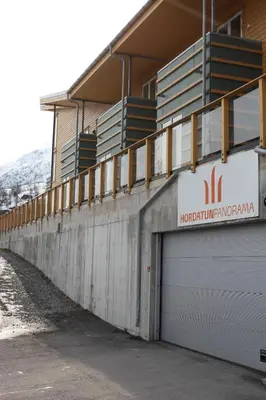a building with a garage with a sign on it at Hordatun Apartments in Røldal