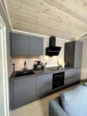 a kitchen with a sink and a stove at Kavliskogen panorama in Isfjorden